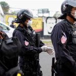 Photo: Riot police preparing to contain people who were detained for violating El Salvador’s nationwide lockdown measures in San Salvador, El Salvador [Jose Cabezas/Reuters]